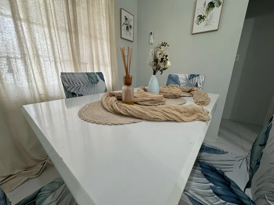 Close view of the white dining table with woven placemats