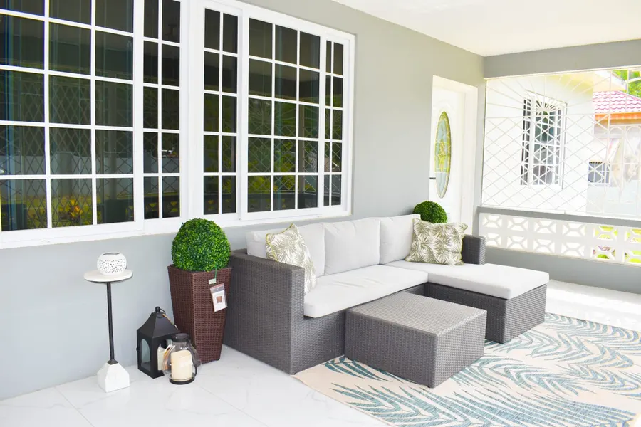 The front veranda with a rattan sectional sofa and lanterns